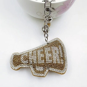 Detail of megaphone shaped keychain with CHEER rhinestones and silver metal hardware