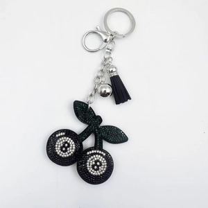 Crystal rhinestone cherry keychain with black 8-ball motif and leather tassel
