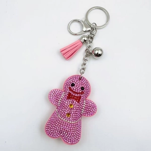 Pink rhinestone gingerbread man keychain with matching tassel and silver bell detail