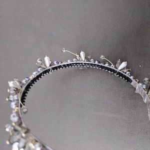 Detail view of handmade headband with white pearls, grey crystals and non-slip black teeth