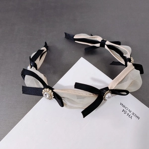 Elegant black ribbon mesh headband with pearls and rhinestones on display card