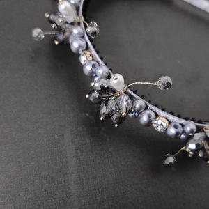 Detailed macro view of hand-beaded flower headband with grey pearls and crystal beads