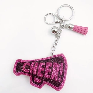 Detailed view of pink rhinestone megaphone keychain with CHEER text and leather tassel