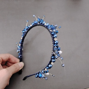 Detail of blue crystal and pearl flower headband with handmade gold wire wrapping