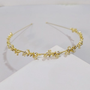 Detail of golden floral headband featuring white opal petals and sparkling crystal accents