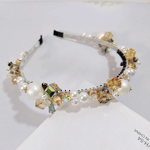 Detailed macro view of handmade headband with luxury white pearls and crystal flowers