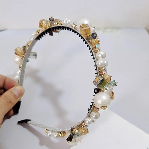 Detail of luxury pearl headband with amber crystals and anti-slip teeth for hair styling