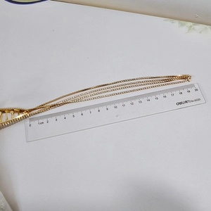 Detail view of golden tassel hair claw with 11cm rhinestone fringe measurement