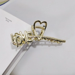 Elegant gold metal shark hair clip with hollow heart and LOVE letter design for women
