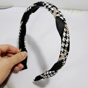 Detail of houndstooth and satin headband with sparkling rhinestone wrap decoration