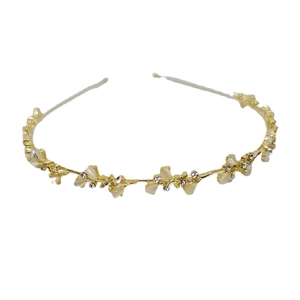 Elegant gold headband with white opal petals and crystal rhinestones on white background