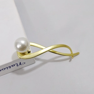 Elegante fermaglio per capelli oro a infinito con grande perla bianca su metallo opaco