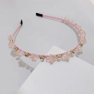 Detail of pink silk headband with woven crystal beads and sparkling rhinestones