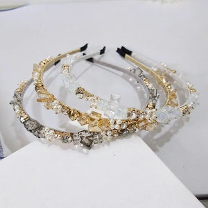 Close-up of handmade crystal headbands with interwoven pearls and sparkling rhinestones