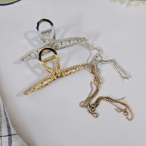 Elegant gold and silver metal hair claws with sparkling rhinestone tassels for women