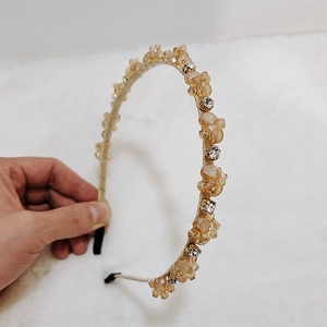 Detail of handmade champagne crystal beaded headband with amber glass rhinestones