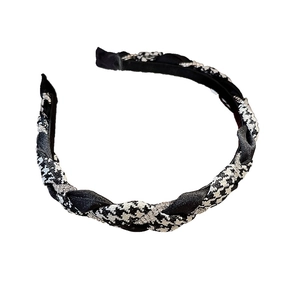 Houndstooth braided headband with sparkling rhinestone accents on a white background