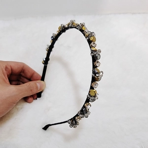 Detail of handmade crystal beaded headband with gold and grey faceted rhinestones