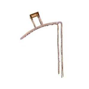 Elegant champagne gold metal hair claw with long tassel chains and sparkling rhinestones