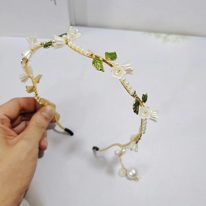 Serre-tête muguet élégant avec perles et émail vert sur une monture dorée chic