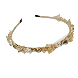 Elegant gold headband with champagne crystals and white pearls in a woven craft design