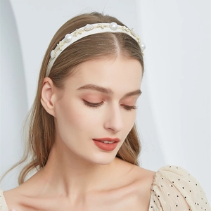 Detail of elegant white pearl headband with gold starfish and shell oceanic charms
