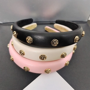 Detail of PU leather headband with golden rose rivets in black, beige and pink