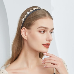 Detail of navy satin headband with white pearls, gold starfish, and shell elements