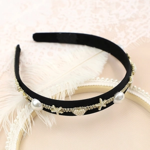 Detail of velvet headband with golden weave, large pearls and starfish charm accents
