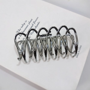 Detailed view of silver wave-shaped metal hair claw clip with smooth alloy finish