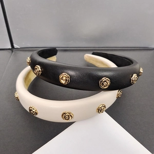 Set of two wide camellia hairbands in black and cream leather with gold rose metal accents