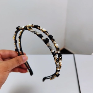 Detail of a double-layer headband featuring sparkling crystals and white faux pearls