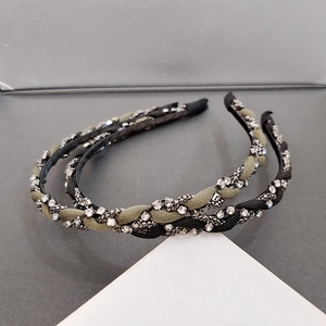 Detail view of woven rhinestone headbands in olive green and black French style