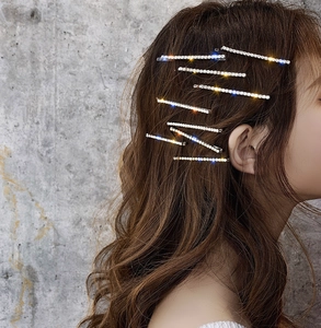 Sparkling rhinestone hair pins on model with brown hair showing side styling view