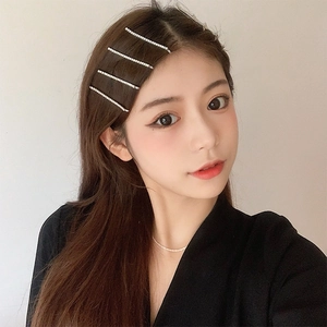 Sparkling rhinestone bobby pin set in silver metal finish worn by model on hair