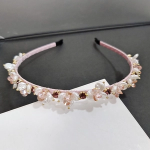 Elegant floral headband with pink crystals and pearls on satin-wrapped band for women