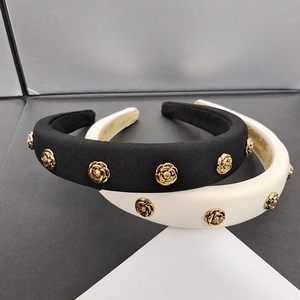 Detailed view of black and beige headbands with elegant golden 3D rose metal ornaments