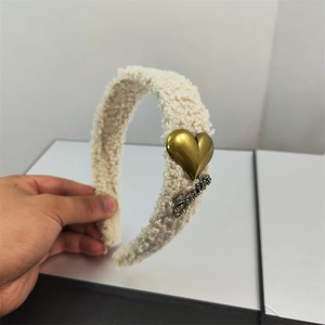 Plush cream faux fur headband featuring gold heart accent and sparkling rhinestone letters