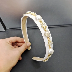 Detail of French style pearl headband with gold chain and starfish embellishments