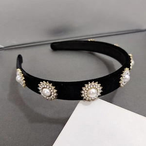 Detailed close-up of velvet headband featuring sunflower pearl and rhinestone accents