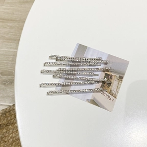 Close-up of 8-piece set silver alloy hair clips with white sparkling rhinestones