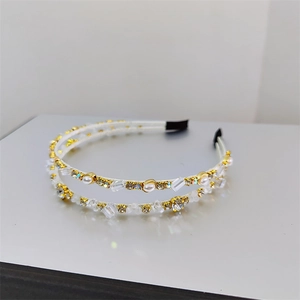 Detail of elegant gold headbands with double-row crystals, faux pearls and anti-slip tips