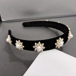 Vintage black velvet headband featuring sparkling rhinestone sunflower and pearl embellishments