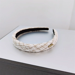 Elegant off-white tweed padded headband with a gold metal accent in French retro style