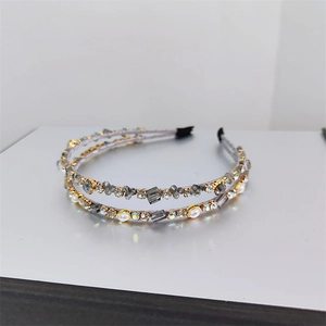 Detail of elegant double-layered hairband with purple fabric and crystal beads