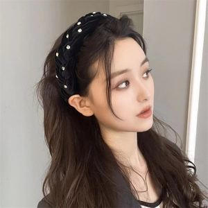 Elegant black velvet braided headband with white rhinestones on a female model
