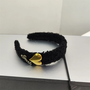 Detail of black fleece headband with golden heart and rhinestone Smile lettering