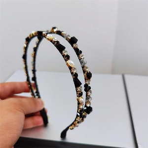 Detailed close-up of double-row headband with black crystals and faux white pearls