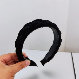 Detail of black velvet braided headband showing inner plastic anti-slip teeth texture