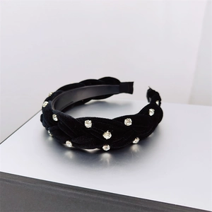 Close-up of black velvet braided headband with sparkling silver rhinestones